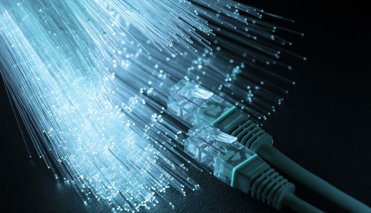 Decorative graphic of cable and lit up fibers