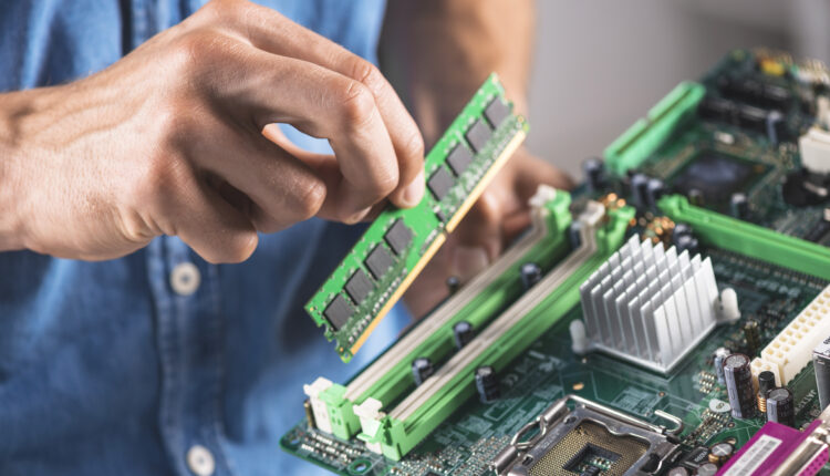 Decorative image of engineer installing RAM module